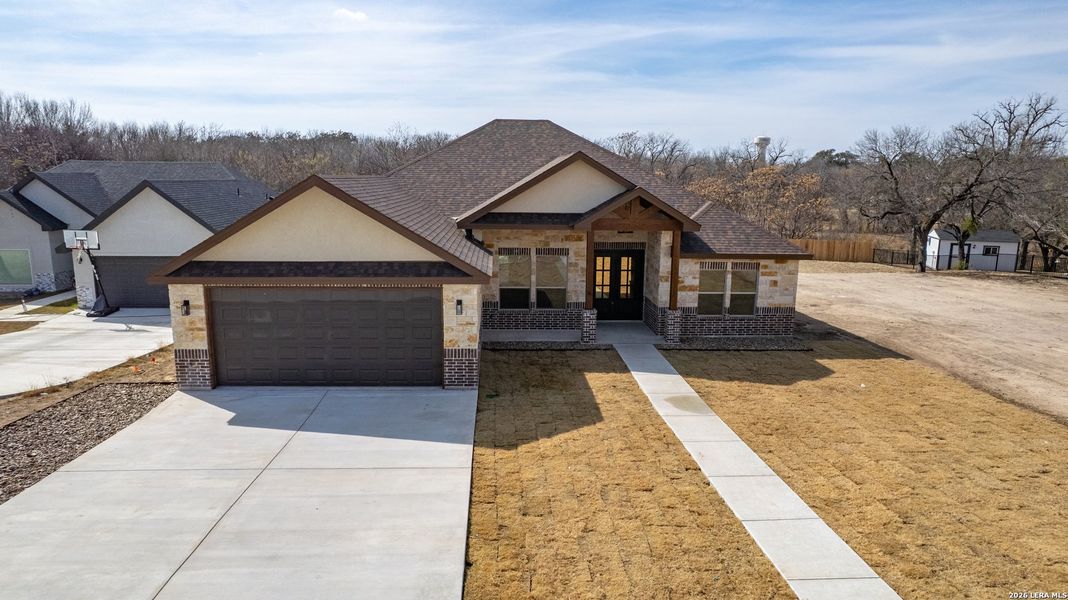 Front exterior of a new home in , Uvalde, TX, highlighting curb appeal (Image 24).