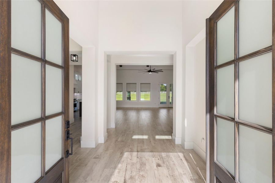 Come on in! The wooden and glass door entry is inviting and showcases the beautiful tile floors that lead you to the living room. Come on in! The wooden and glass door entry is inviting and showcases the beautiful tile floors that lead you to the living room.