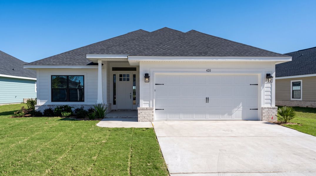 Front exterior of a new home in Riverwalk, Freeport, FL, highlighting curb appeal (Image 1). Front exterior of a new home in Riverwalk, Freeport, FL, highlighting curb appeal (Image 1).