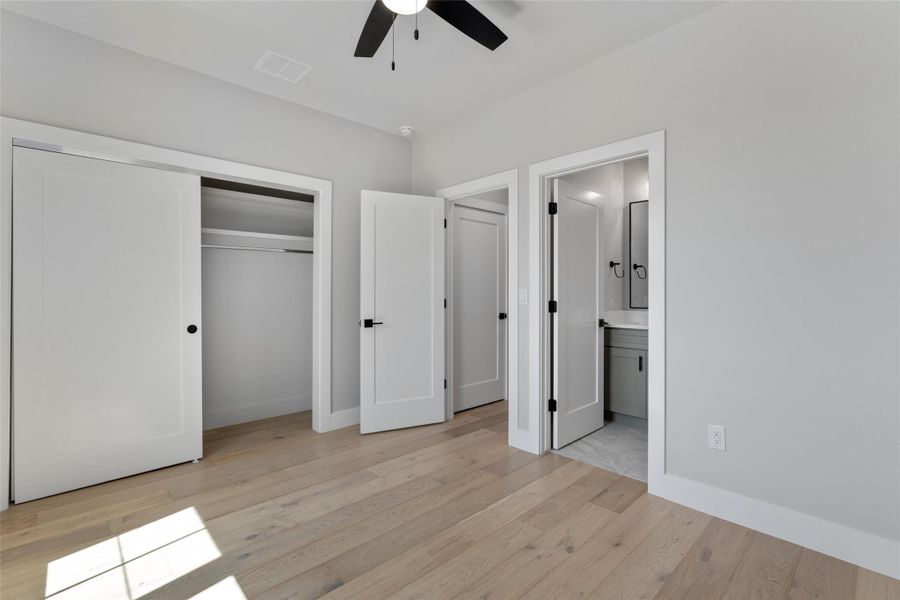 Secondary bedroom featuring hardwood flooring throughout, with a ceiling fan and recessed lighting. Secondary bedroom featuring hardwood flooring throughout, with a ceiling fan and recessed lighting.