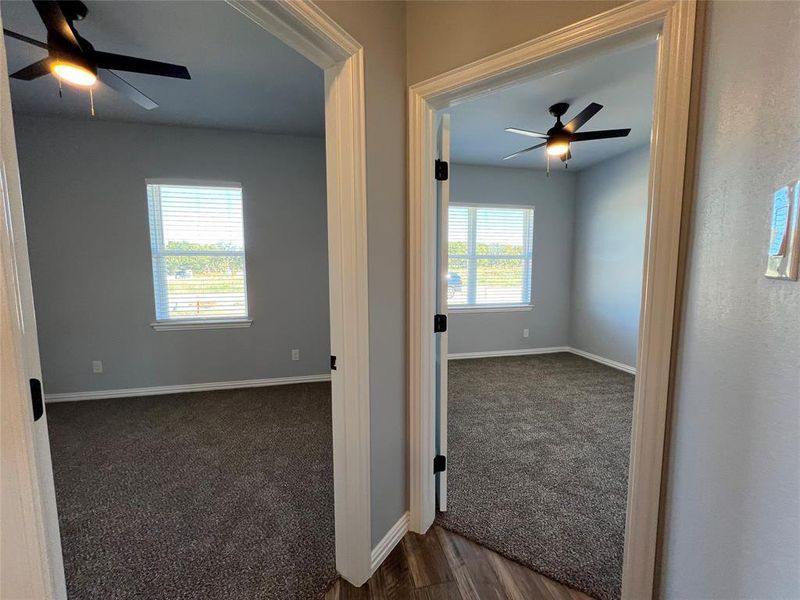 Hall with dark hardwood / wood-style flooring