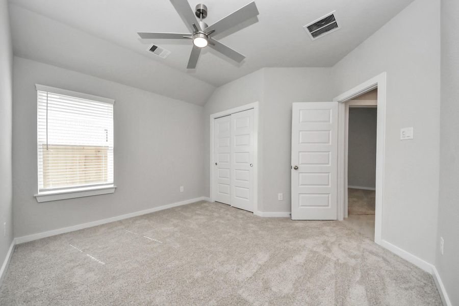 Generously sized secondary bedrooms featuring spacious closets, soft and inviting carpeting underfoot, large windows allowing plenty of natural light, and the added touch of privacy blinds for your personal retreat. Sample photo of completed home with similar floor plan. Actual colors and selections may vary.