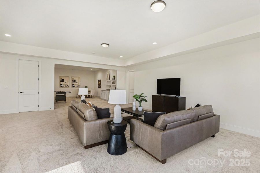 Basement living area overlooking mini kitchen