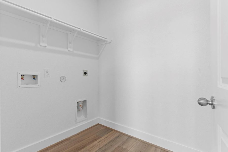 Dedicated utility room with washer and dryer connections, upper hanging rack, and ample space for laundry essentials—designed for convenience and function. **Image Representative of Plan Only and May Vary as Built**.