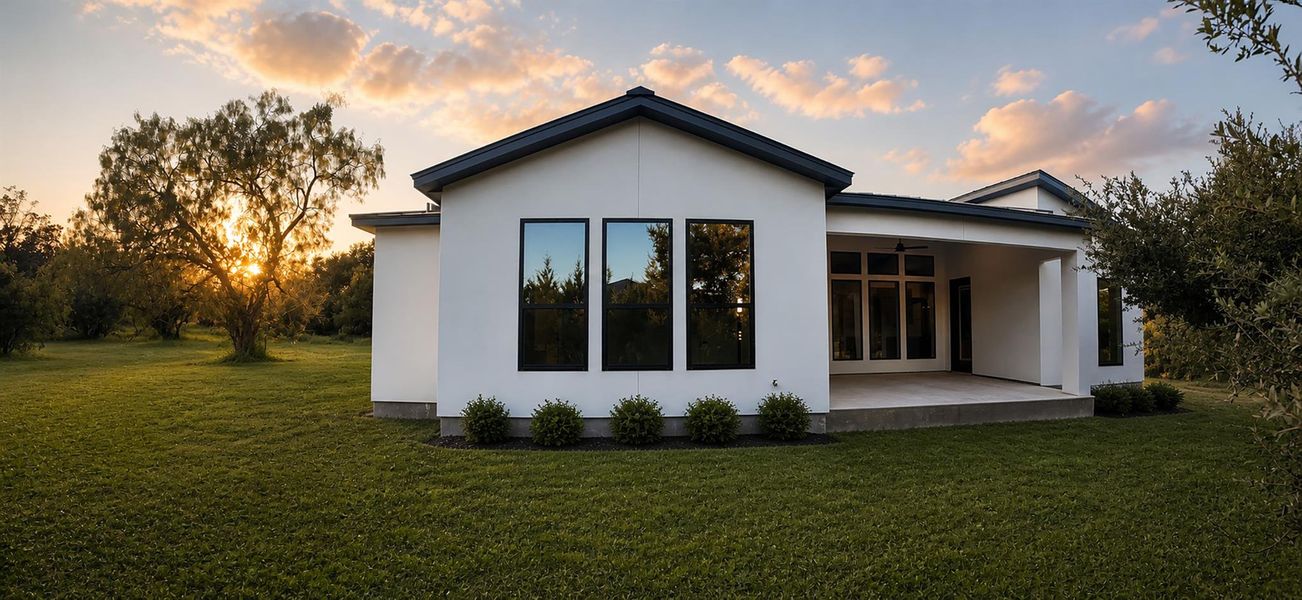 Clean lines and dark-trimmed windows define this modern single-story home overlooking a grassy lawn. Clean lines and dark-trimmed windows define this modern single-story home overlooking a grassy lawn.