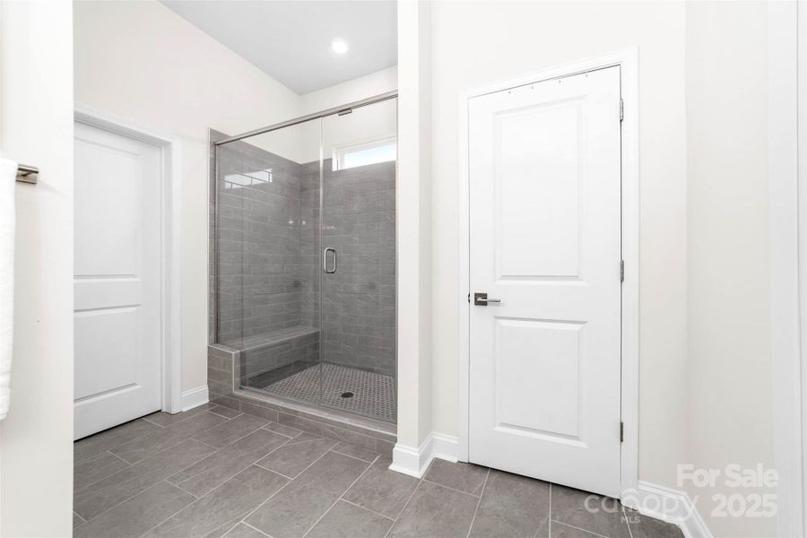 Primary bathroom with oversized shower and linen closet
