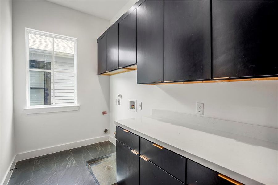 Oversized utility room with ample storage for folding clothes.