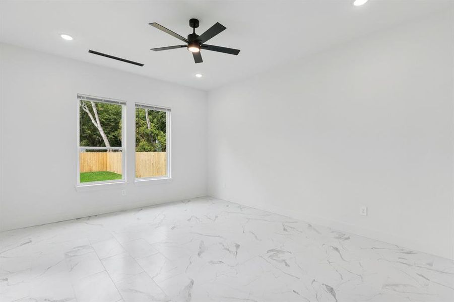 Spare room featuring light marble finish floors, recessed lighting, and a ceiling fan Spare room featuring light marble finish floors, recessed lighting, and a ceiling fan