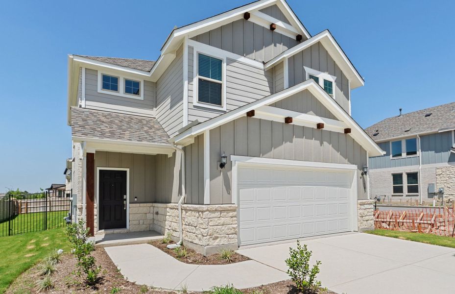 Front exterior of a new home in Santa Rita Ranch, Liberty Hill, TX, highlighting curb appeal (Image 22).