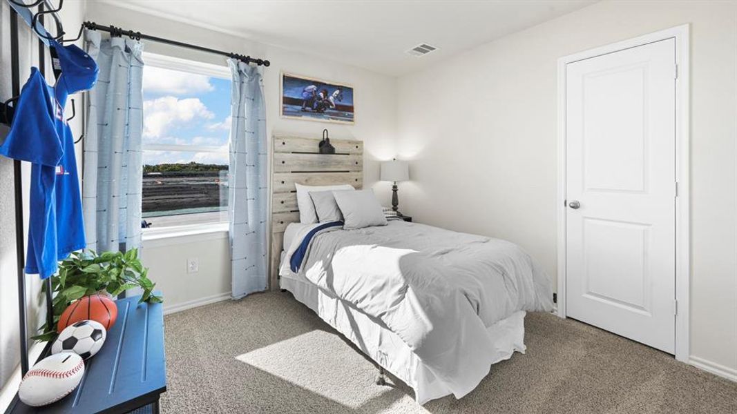 Carpeted bedroom with baseboards