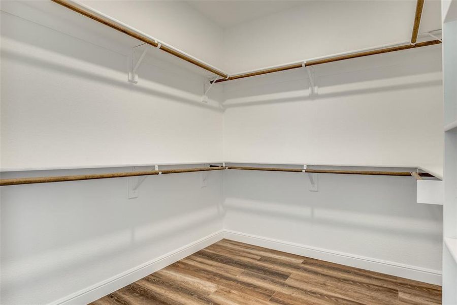 Spacious closet with light wood-style floors