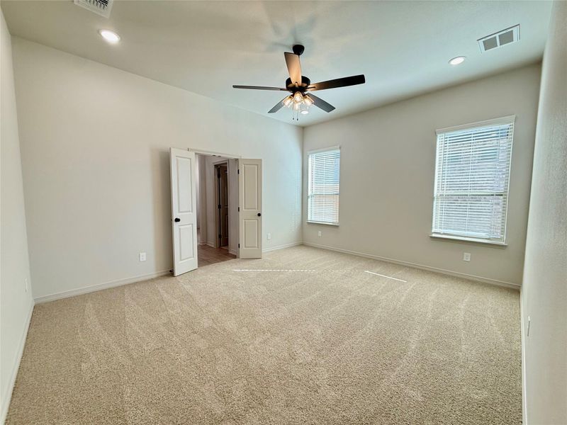 Unfurnished bedroom with light colored carpet, recessed lighting, and ceiling fan
