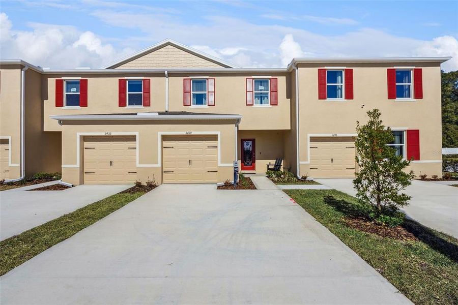 Front exterior of a new home in Oak Pointe, Apopka, FL, highlighting curb appeal (Image 1). Front exterior of a new home in Oak Pointe, Apopka, FL, highlighting curb appeal (Image 1).