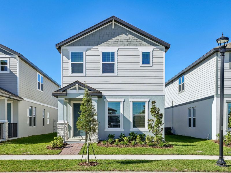 Front exterior of a new home in The Meadow at Crossprairie Bungalows, St. Cloud, FL, highlighting curb appeal (Image 1). Front exterior of a new home in The Meadow at Crossprairie Bungalows, St. Cloud, FL, highlighting curb appeal (Image 1).