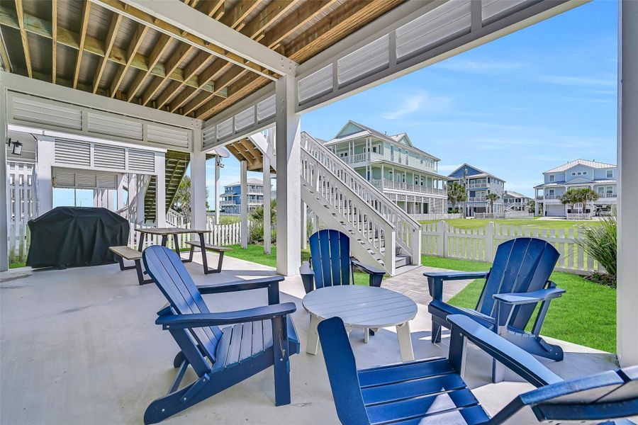 The expansive ground level entertaining area creates the ultimate setup for gatherings, grilling, and relaxing after a day at the beach.