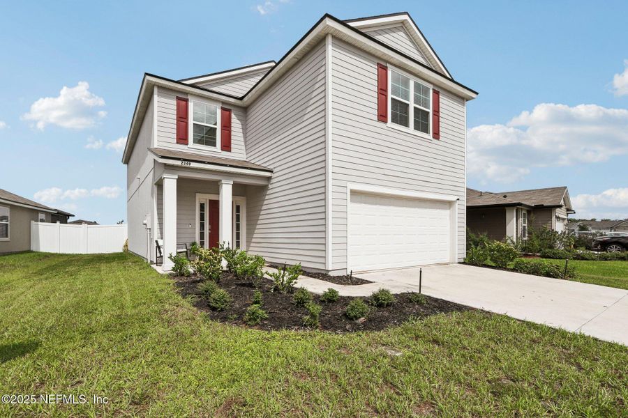Front exterior of a new home in Cross Creek Express, Green Cove Springs, FL, highlighting curb appeal (Image 28).