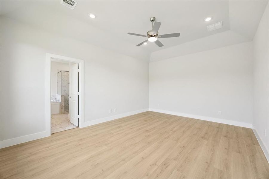 Unfurnished bedroom with light wood-type flooring, recessed lighting, ceiling fan, and connected bathroom