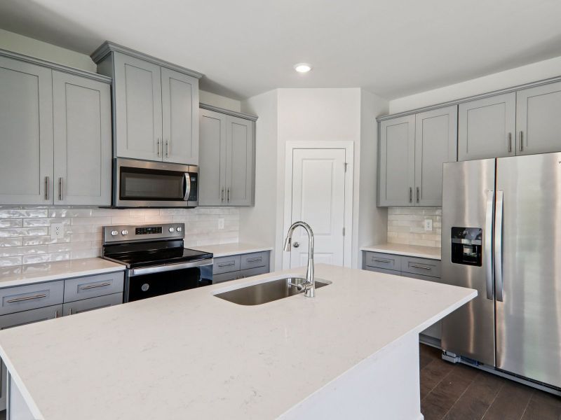 The oversized kitchen island makes meal-prepping much easier.