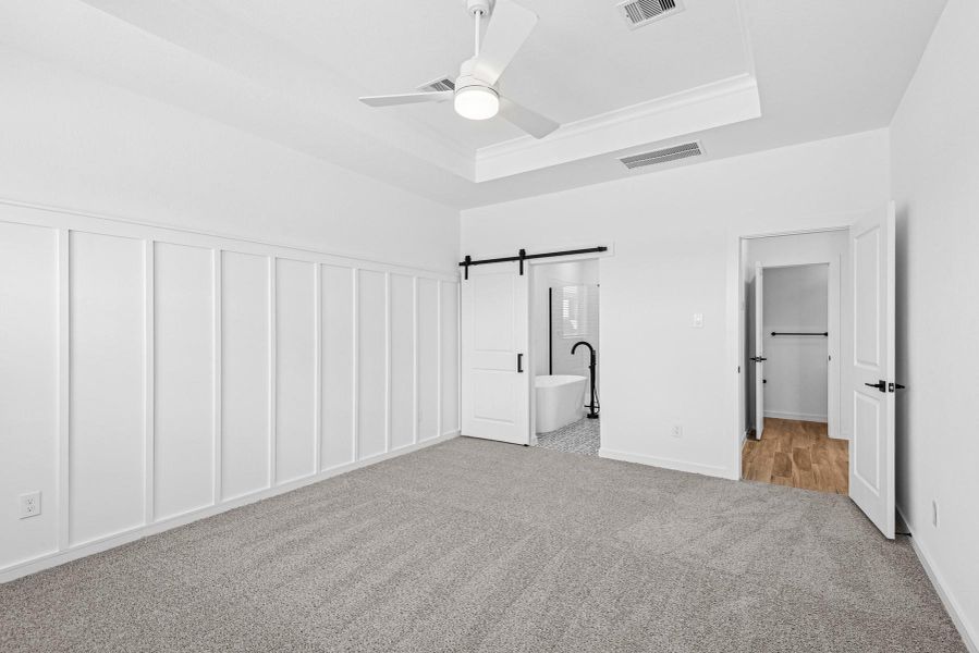 Tranquil primary suite with feature wall Tranquil primary suite with feature wall