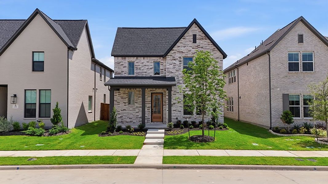 Front exterior of a new home in Light Farms Brenham - 40' Lots, Celina, TX, highlighting curb appeal (Image 28). Front exterior of a new home in Light Farms Brenham - 40' Lots, Celina, TX, highlighting curb appeal (Image 28).