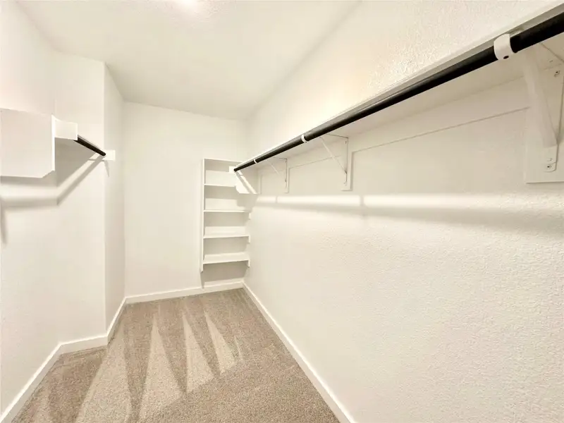 Walk in closet with light carpet Walk in closet with light carpet