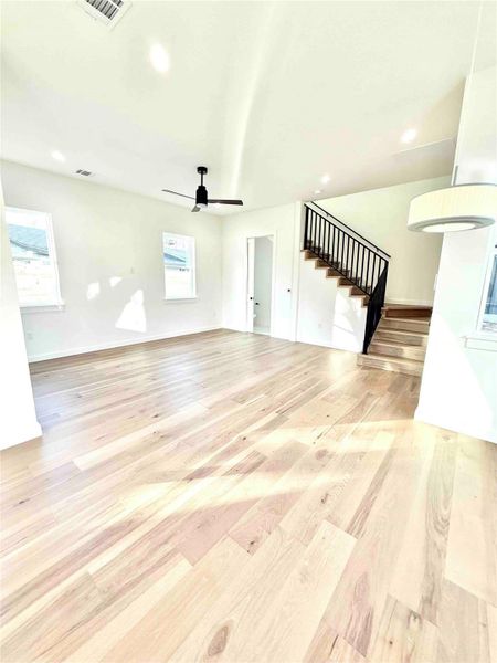 Unfurnished living room with stairs, recessed lighting, light wood finished floors, and ceiling fan