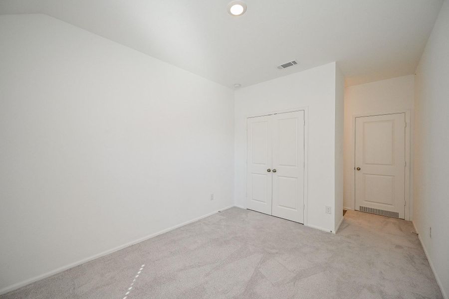 Another bedroom offers a versatile canvas for personalization, featuring white walls and a light gray carpet that exudes modern simplicity. Another bedroom offers a versatile canvas for personalization, featuring white walls and a light gray carpet that exudes modern simplicity.