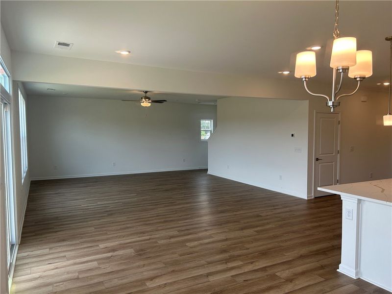 An open floorplan features recessed lighting and d