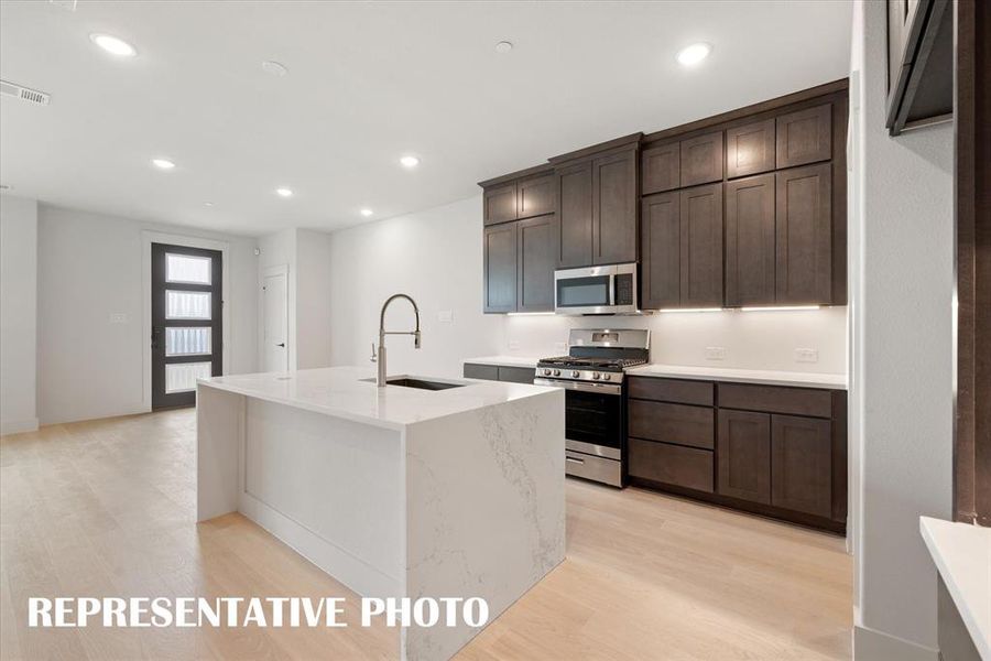 Your new dream kitchen features fantastic storage, designer finishes and tons of space!  REPRESENTATIVE PHOTO