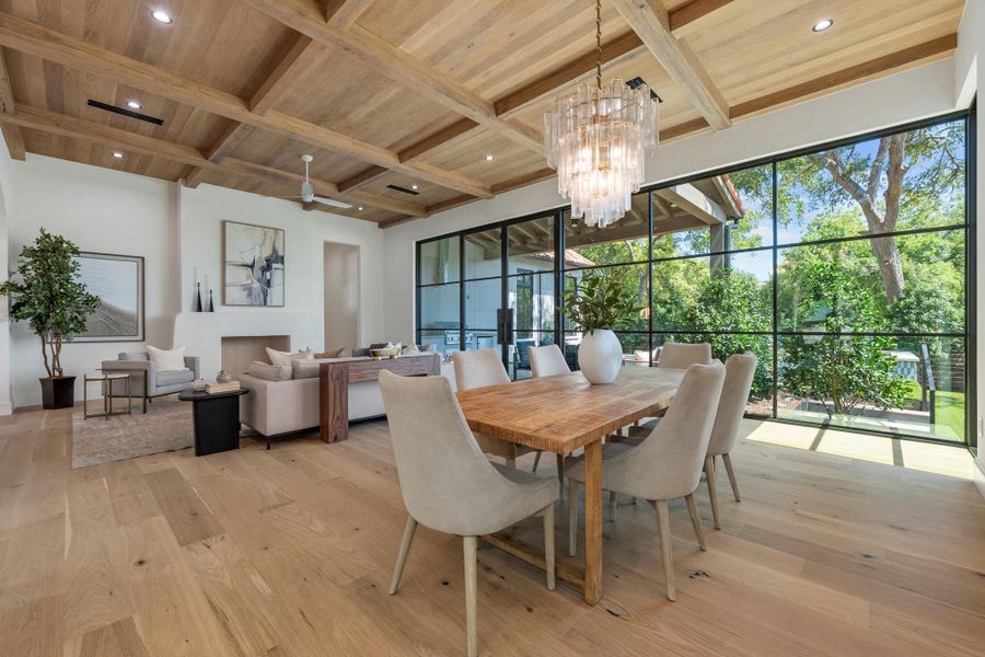 Exquisite wood-coffered ceilings and massive steel-framed windows elevate this open dining space.