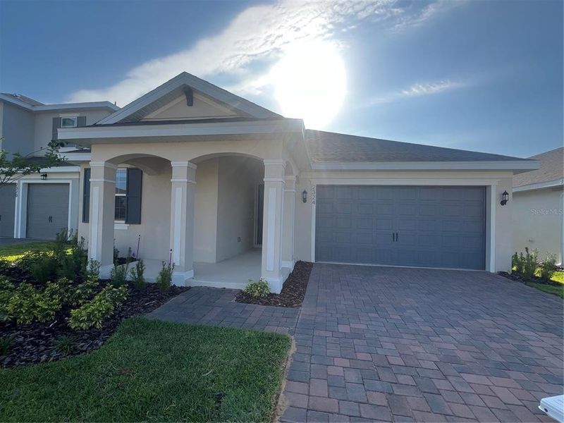 Front exterior of a new home in Hills of Minneola, Minneola, FL, highlighting curb appeal (Image 1).