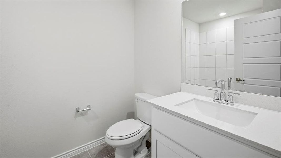 Half bath featuring vanity, tile patterned floors, and recessed lighting Half bath featuring vanity, tile patterned floors, and recessed lighting