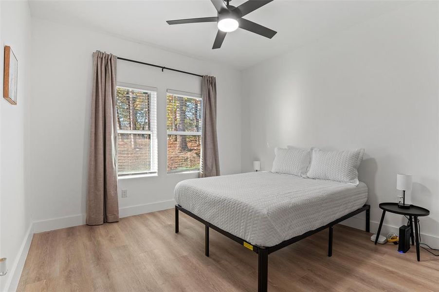 Bedroom with light wood-type flooring and ceiling fan