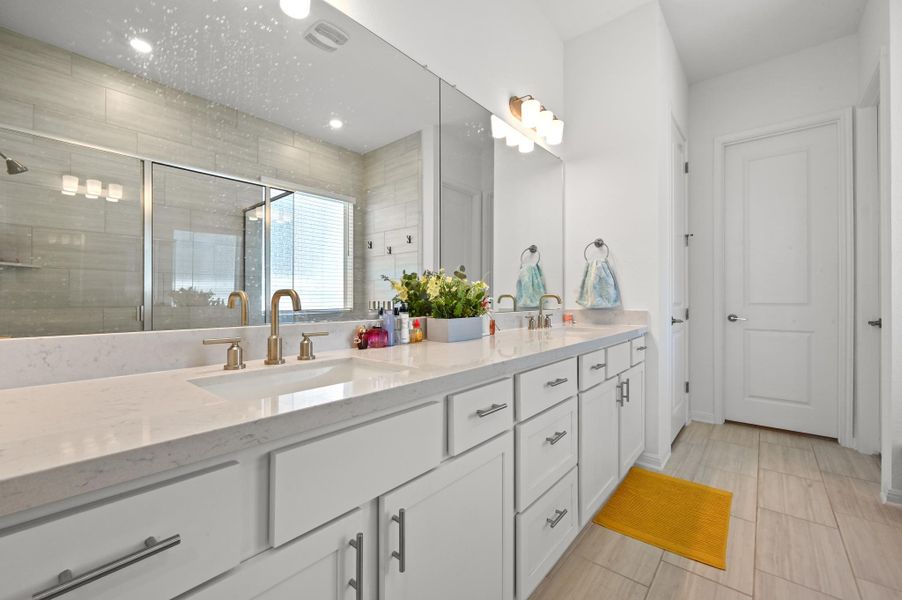 Clean lines and a long double vanity define this modern, light-filled bathroom design.