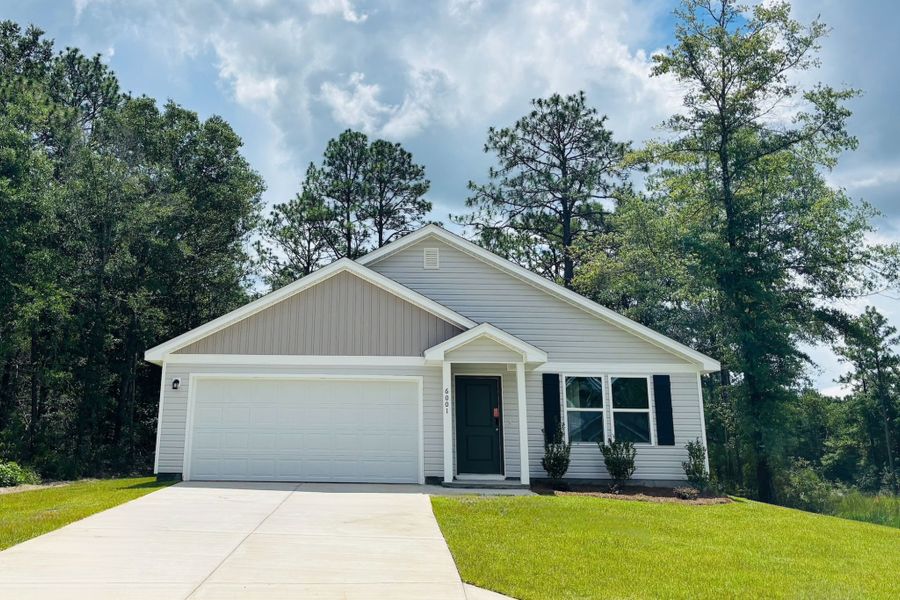 Front exterior of a new home in Meadow Creek, Crestview, FL, highlighting curb appeal (Image 1).