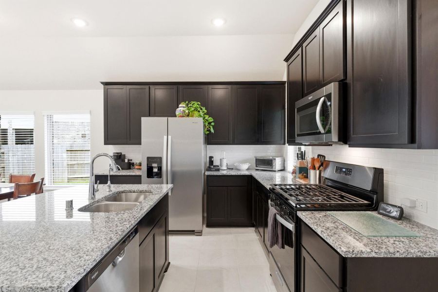 Gas stove, window about the sink and walk in pantry.  This is a kitchen you want to see.