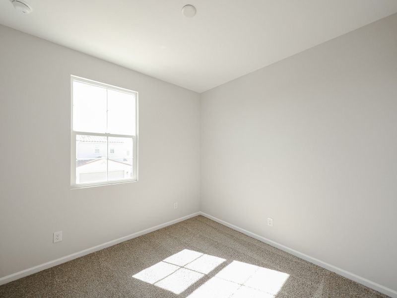A room with a window and a rug. A room with a window and a rug.