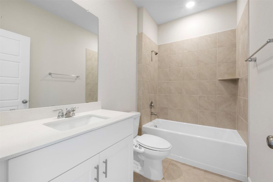 Secondary bathroom located downstairs just off of the main entry of the home