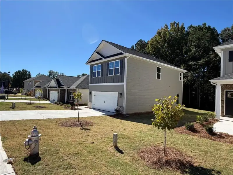 Front exterior of a new home in Canterbury Villas, Carrollton, GA, highlighting curb appeal (Image 19).