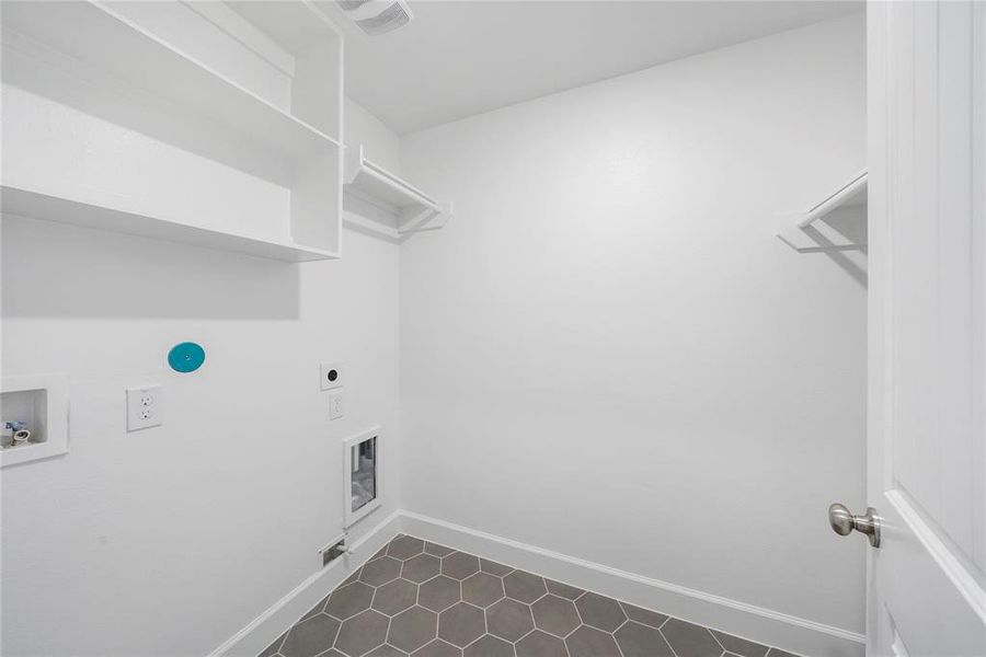 The Utility Room is located on the second floor, and features built-in shelves for additional storage. (Sample photos of a completed Bordeaux floor plan. The image may feature alternative selections and/or upgrades.)