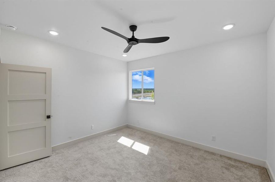 Spare room featuring light carpet, a ceiling fan, and recessed lighting Spare room featuring light carpet, a ceiling fan, and recessed lighting