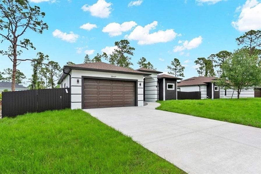 Front exterior of a new home in , Lehigh Acres, FL, highlighting curb appeal (Image 2). Front exterior of a new home in , Lehigh Acres, FL, highlighting curb appeal (Image 2).
