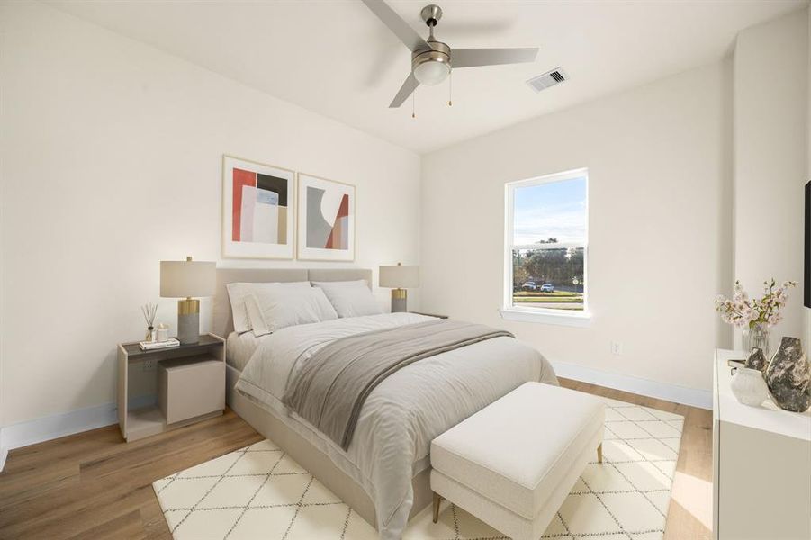 Secondary bedroom features wood-like floors, custom paint, ceiling fan with lighting and a large window with ample natural light. *Virtually staged