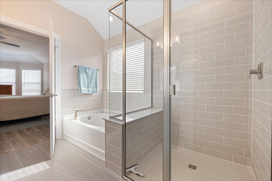 Primary bathroom with double vanity, separate garden tub and shower.