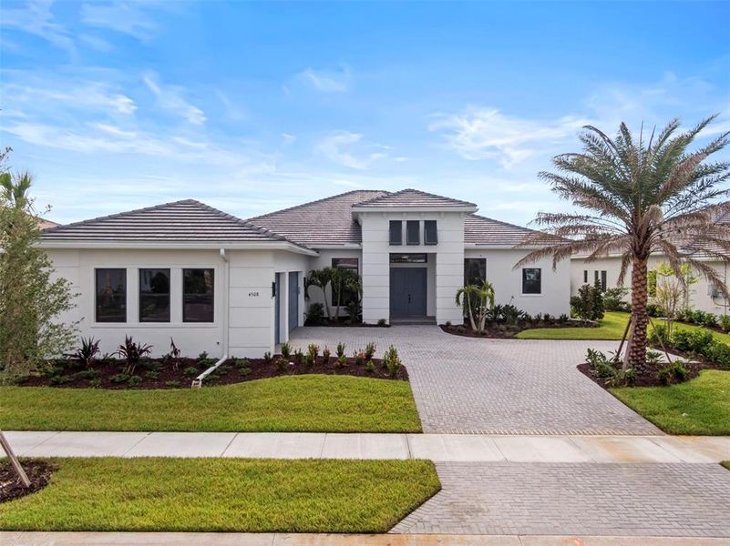Front exterior of a new home in Artistry Sarasota, Sarasota, FL, highlighting curb appeal (Image 1).