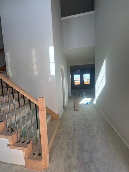 Hallway with a high ceiling and stairway