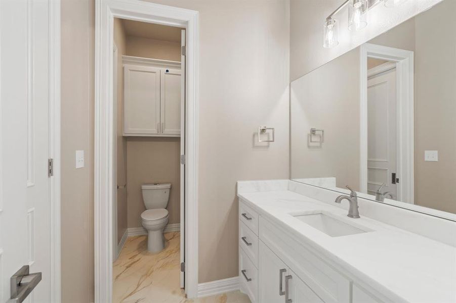 Bathroom featuring vanity and toilet