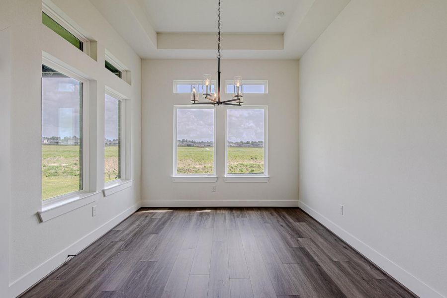 The dining area is filled with natural light, creating a bright and inviting space for everyday meals or special occasions The dining area is filled with natural light, creating a bright and inviting space for everyday meals or special occasions