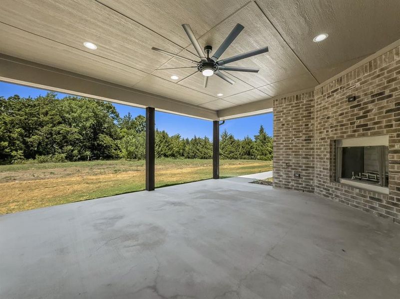 View of patio / terrace with ceiling fan and view of wooded area View of patio / terrace with ceiling fan and view of wooded area