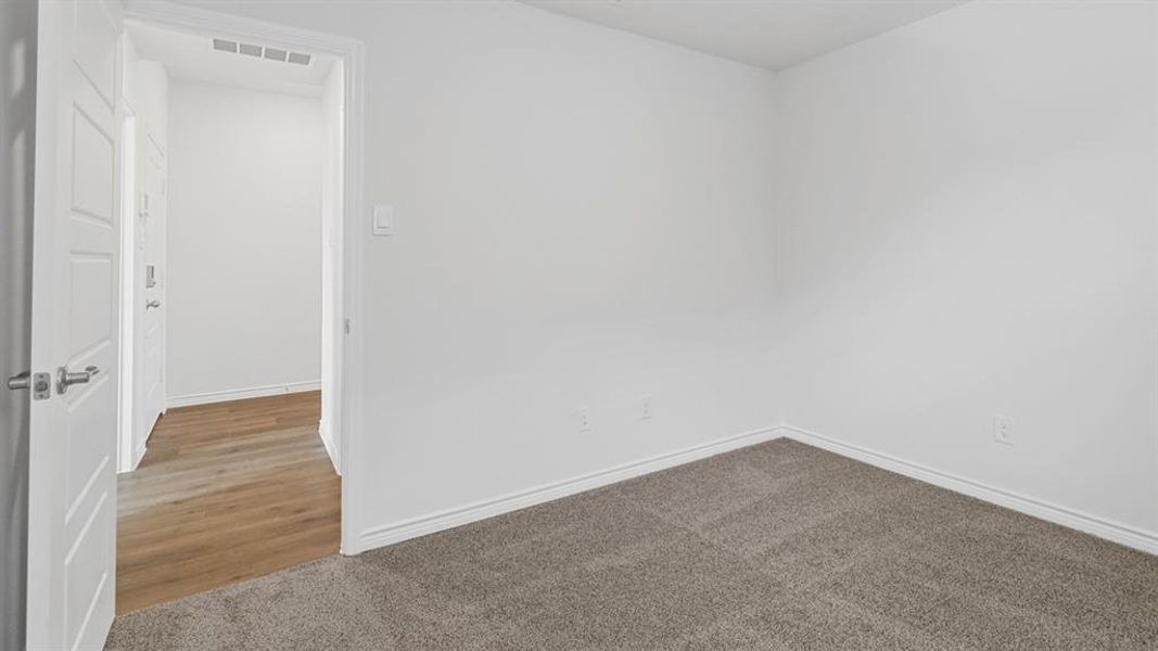 Carpeted empty room featuring baseboards